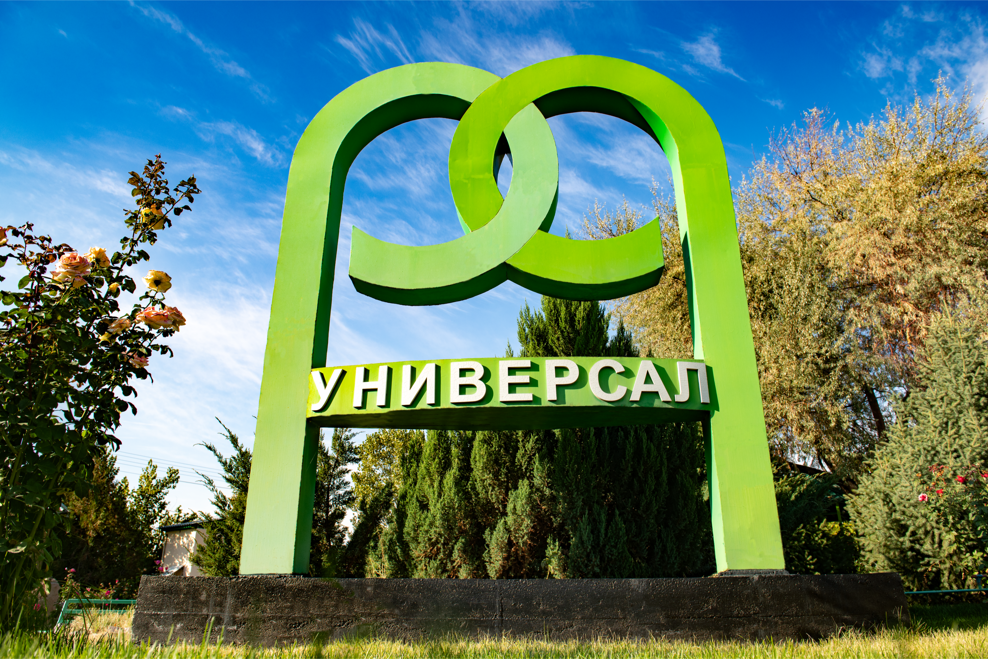BAM_9519 Вывеска компании Универсал на фоне зелёной территории